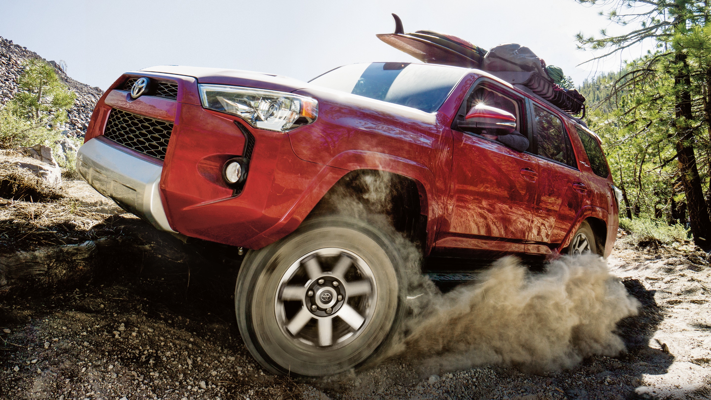 Image of a red 2019 Toyota 4Runner driving up a dirt road.